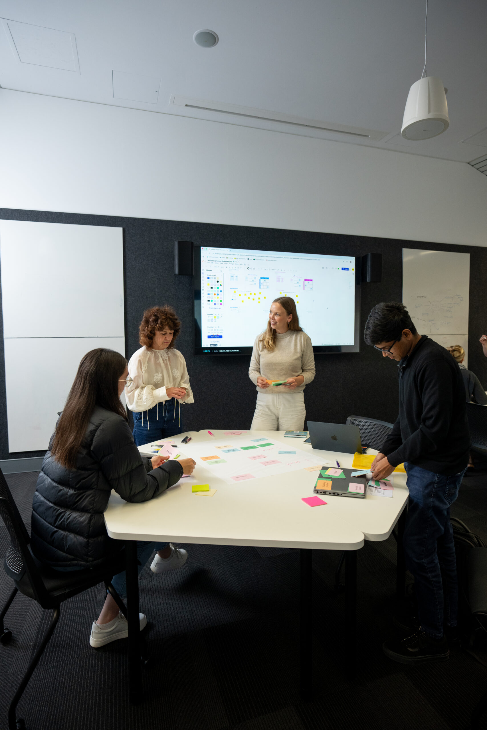 innovative university classroom with students and teacher working together